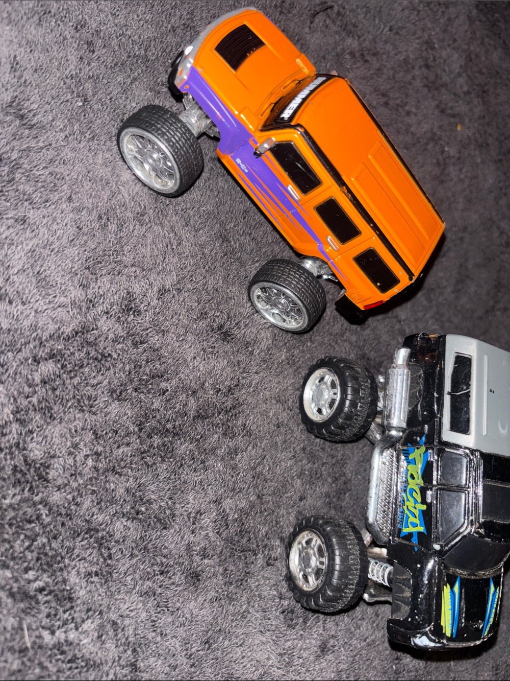 Source Unknown Orange and Purple Monster Truck Toy Pair